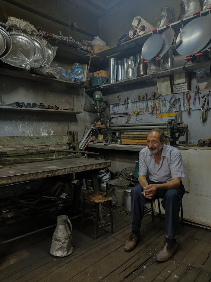 Elderly Man Sitting at Workshop